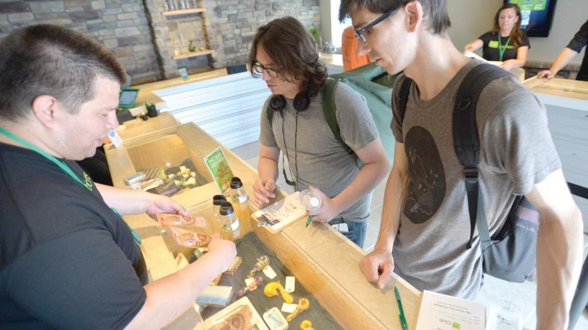 Jorge Molina, left, helps Blake Davis and Andy Adams decide what to buy at 2020 Solutions in Bellingham in this photo from July 10, 2014. Both 2020 stores in Bellingham have received approval from the Washington State Liquor and Cannabis Board to sell medical marijuana.