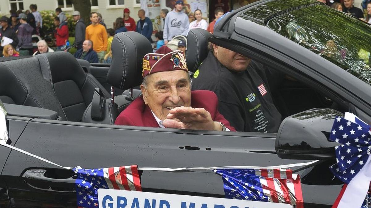 World War II pilot Joe Moser waves to the crowd during the Blossomtime Parade in Bellingham on May 23, 2015. Moser died Dec. 2, 2015. He was 94.