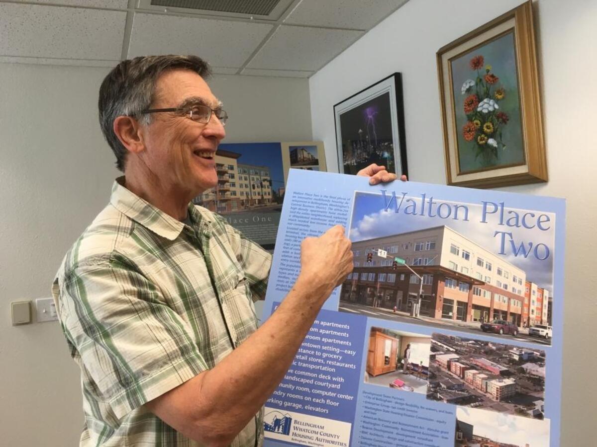 John Harmon, executive director of the Bellingham/Whatcom Housing Authorities, shows a drawing of one of the agency’s apartment buildings designed for lower-income residents.