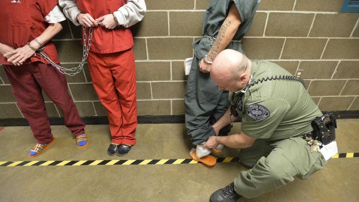 Inmates are cuffed at the Whatcom County Jail Thursday, March 26, 2015, in Bellingham. The city has signed a contract with a jail in King County to take some inmates if the Whatcom jail and the Yakima County Jail don’t have room available.