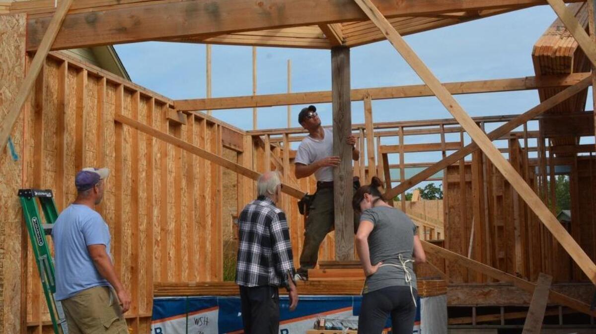 Nate Ashby, from left, Carl Seiler, Kyle Jay and Karen Seiler work on one of the Drayton Reach homes south of downtown Blaine.