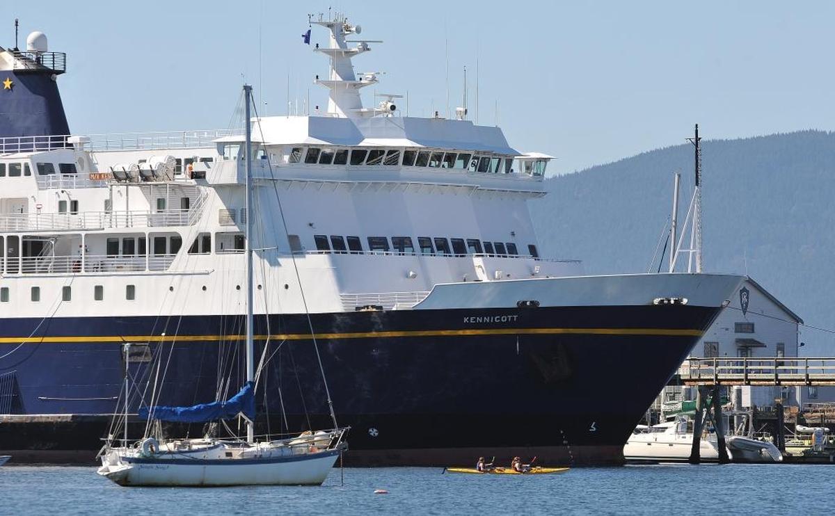 The MV Kennicott dwarfs a pair of kayakers as it is moored at the Bellingham Cruise Terminal in Fairhaven. Alaska’s governor’s budget proposal has deep cuts slated for the Alaska Marine Highway System, potentially eliminating the Alaska-to-Bellingham route.