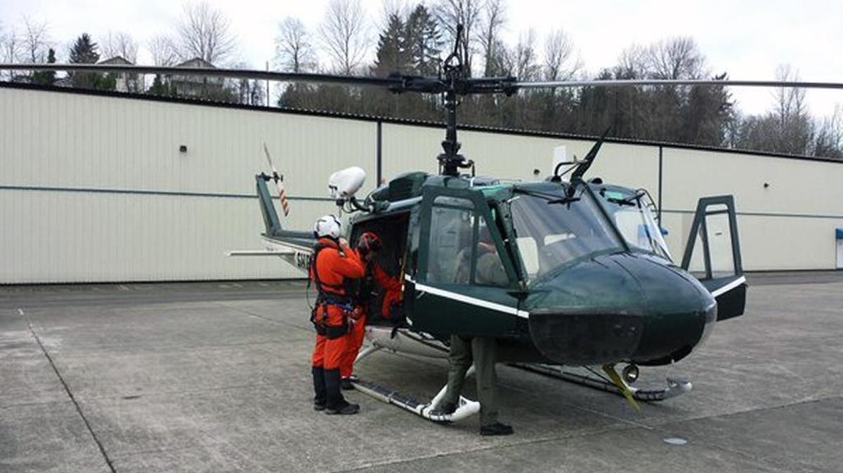 A helicopter from King County Air Support gets ready to launch Monday, Jan. 25 to assist in the search for a person who died in an avalanche near Mt. Baker Ski Area on Sunday.