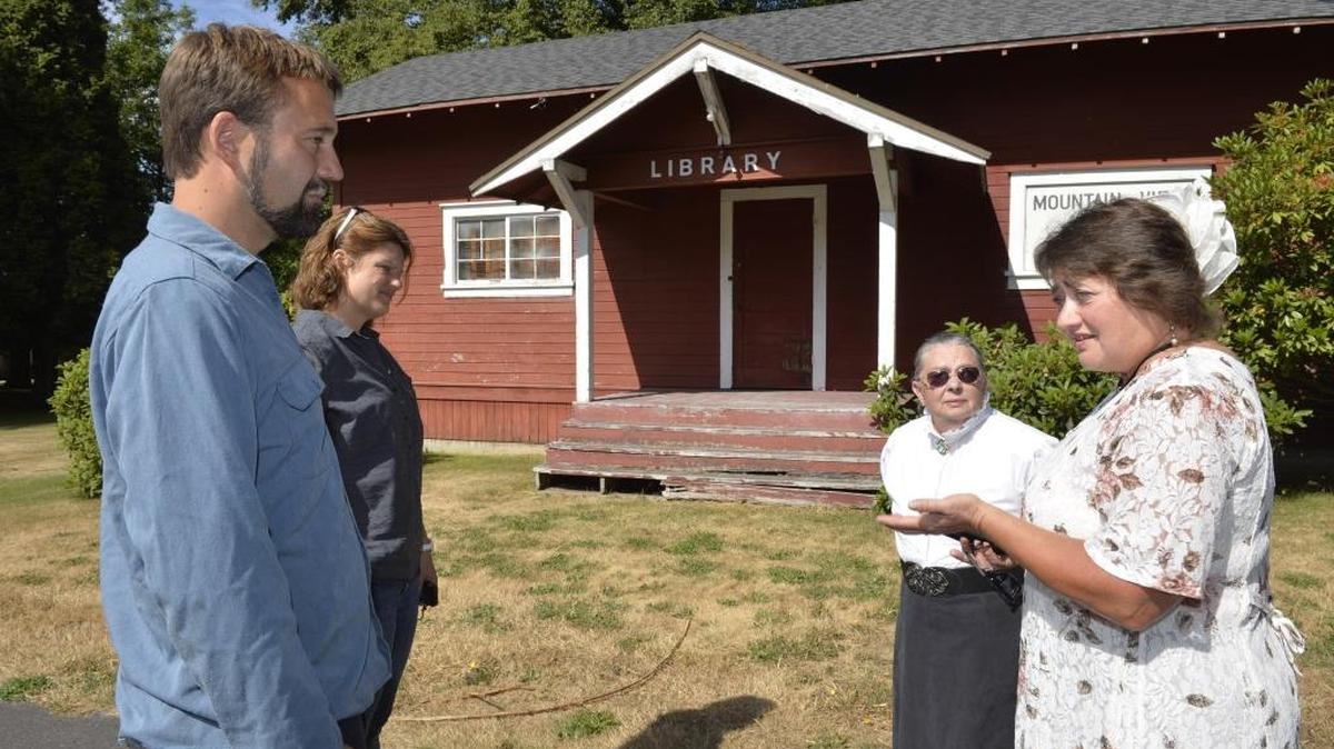 
Alcoa Intalco Works engineer Travis Linds, left, and public relations manager Raina Clark, talk to Ferndale Heritage Society's Linda Harkleroad and Bonnie Wiesen on June 25, 2015, about moving the 1916 schoolhouse in the background from Intalco property to Pioneer Park in Ferndale.
