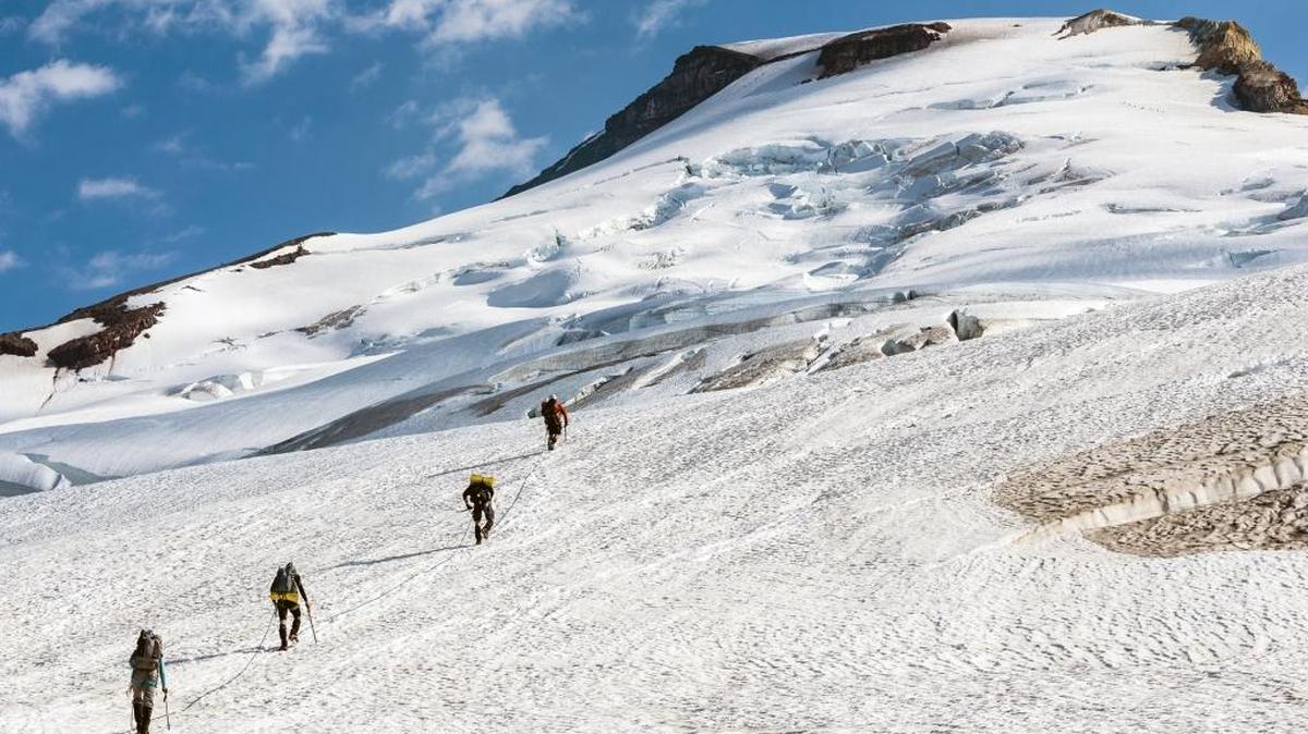 From top, Daniel Probst, Beat Jegerlehner, Aaron Poh and Jill Homer hike up Easton Glacier on their way to the summit of Mount Baker on Aug. 2, 2014 the halfway point of their 108-mile trek from Bellingham Bay to Mount Baker and back. Probst, a Bellingham ultra runner, and others will try to duplicate the feat on Friday, June 3, 2016.