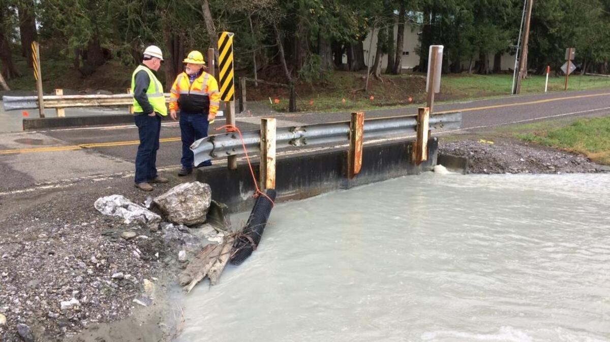 Steve Weaver and Roland Middleton, of Whatcom County Public Works, at the bridge over Swift Creek on Oat Coles Road on Nov. 30, 2016.