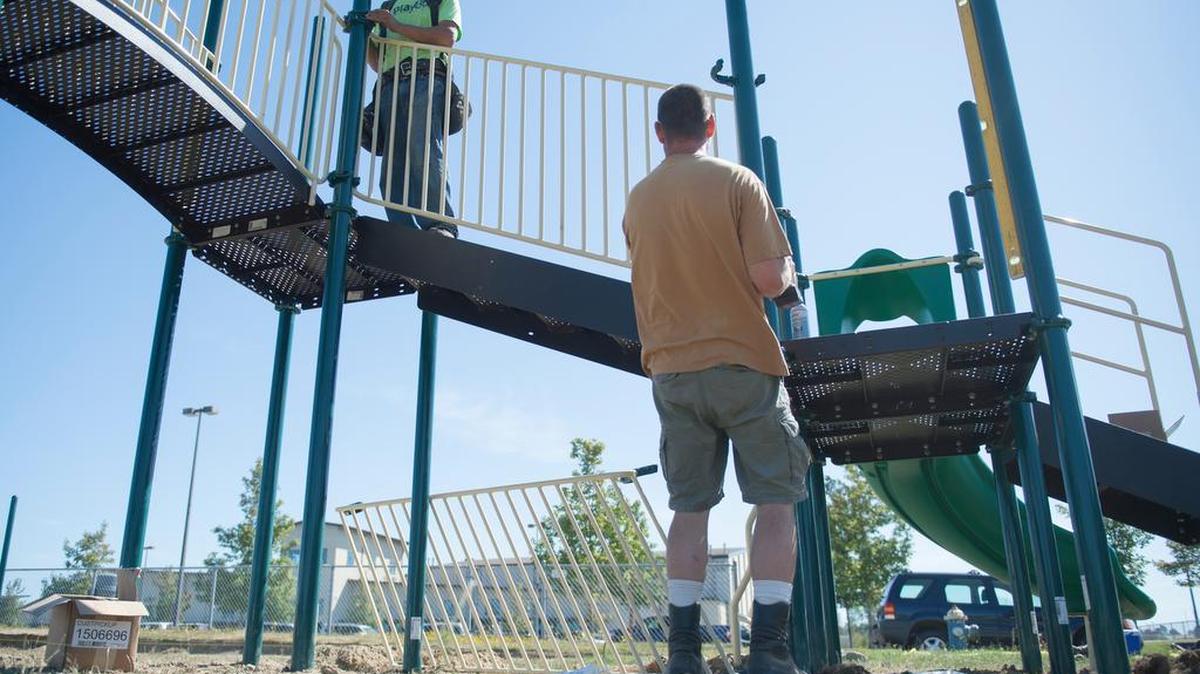 
Ron Cushway, left, and Gary Rogers from R&R Construction install a railing on a new play structure at Blaine Primary School on Wednesday, July 29, 2015. Installing a new play structure was cheaper than moving the old one to make way for an addition to the primary school.
