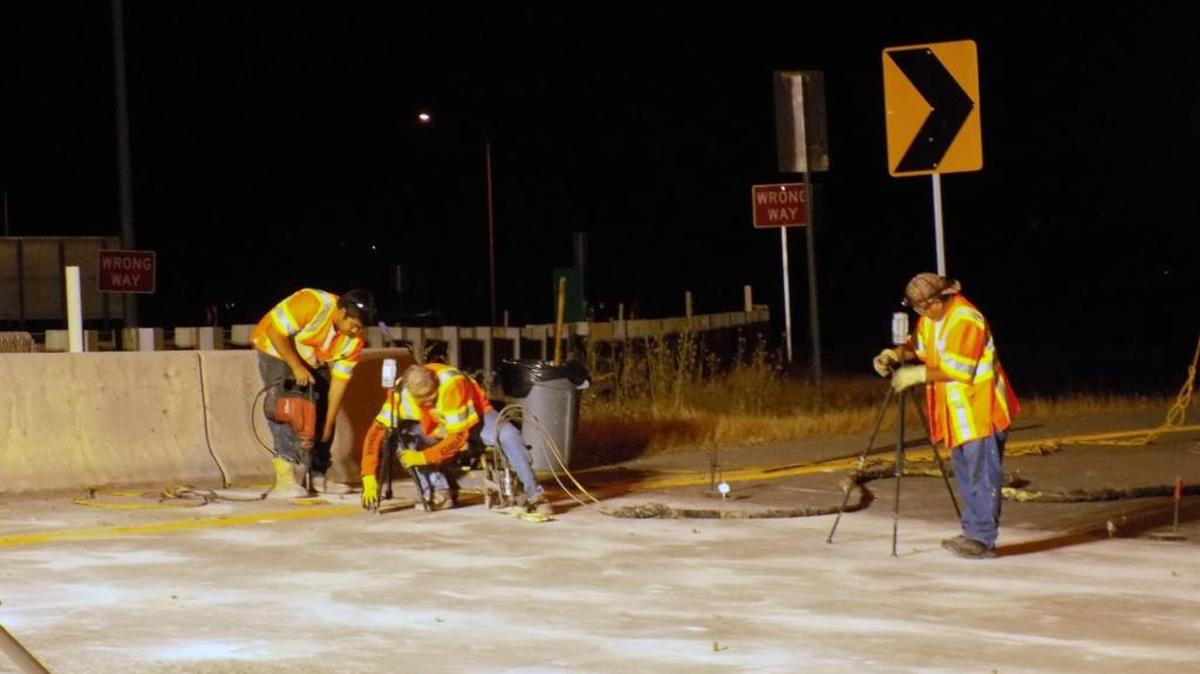 Crews work on a pair of concrete slabs at the Interstate 5-Highway 20 interchange in August.