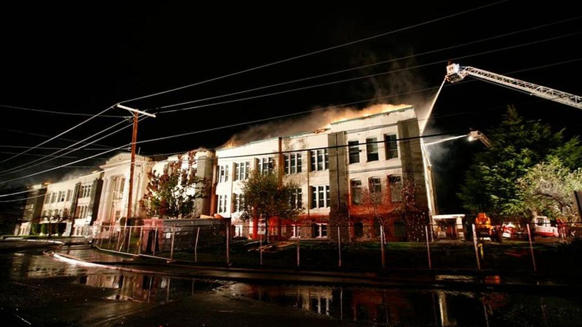 Flames tear across the roof of Whatcom Middle School early Nov. 5, 2009, in a fire that heavily damaged the historic school building.