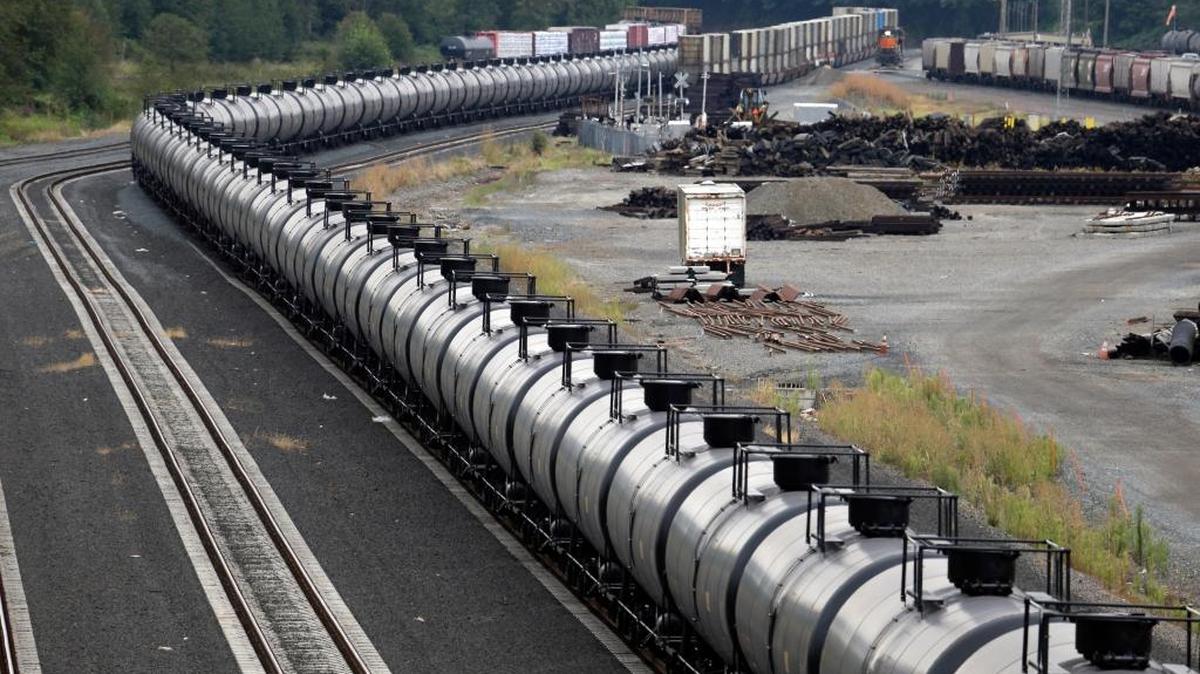 In this Sept. 2, 2014 photo, a northbound oil train sits idled on tracks, stopped by protesters blocking the track ahead, in Everett, Washington. Shell Puget Sound Refinery near Anacortes has suspended its plans to build a rail spur on existing tracks to handle trains carrying crude oil. It would bring in about 60,000 barrels of crude oil a day.