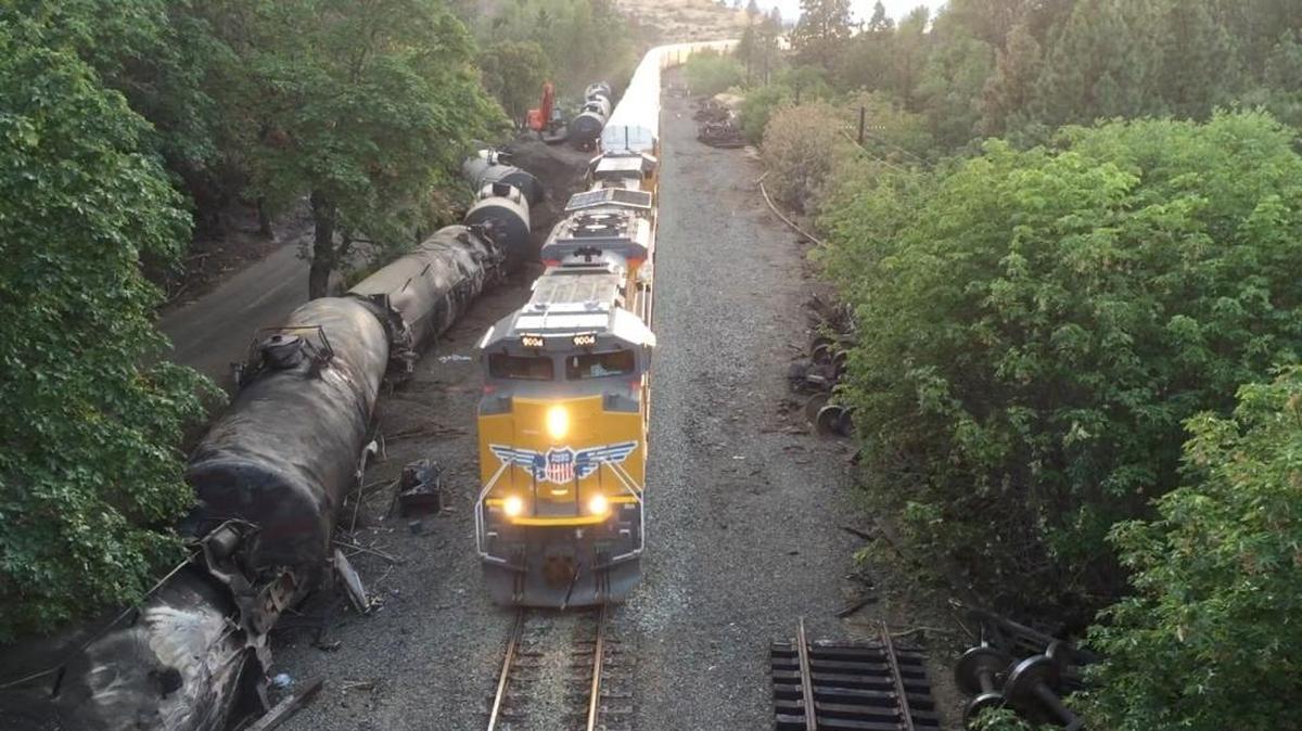FILE - This June 6, 2016, file aerial video image taken from a drone shows crumpled oil tankers lying beside the railroad tracks after a fiery June 3 train derailment that prompted evacuations from the tiny Columbia River Gorge town of Mosier, Ore. U.S. safety officials say they've seen slow progress in efforts to upgrade or replace tens of thousands of rupture-prone rail cars used to transport oil and ethanol, despite a string of fiery derailments.