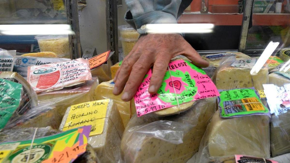 Owner Jeff Margolis, reaches for Nokkelost cheese at the Everybody's Store in Van Zandt Wednesday, Nov. 8, 2017. The small store in rural Whatcom County carries about 60 different cheeses. Everybody's Store will have the 47th annual Cheese Fest, from 11 a.m. to 5 p.m. Saturday, Nov. 19.