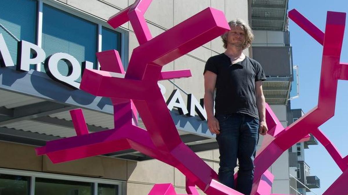 
Swedish artist Jacob Dahlgren stands on his sculpture Constructing a New World while he has photo taken after the piece was installed Tuesday, June 23, 2015, at the corner of Barkley Boulevard and Newmarket Street, in Bellingham. The artwork was commissioned by the Barkley Company and the Talbot family.
