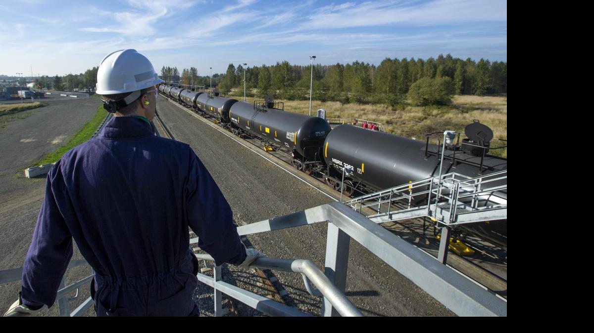 
BP spokesman Scott Dean walks down the stairs of a bridge over BP Cherry Point refinery’s existing rail loop on Thursday Oct. 9, 2014.

