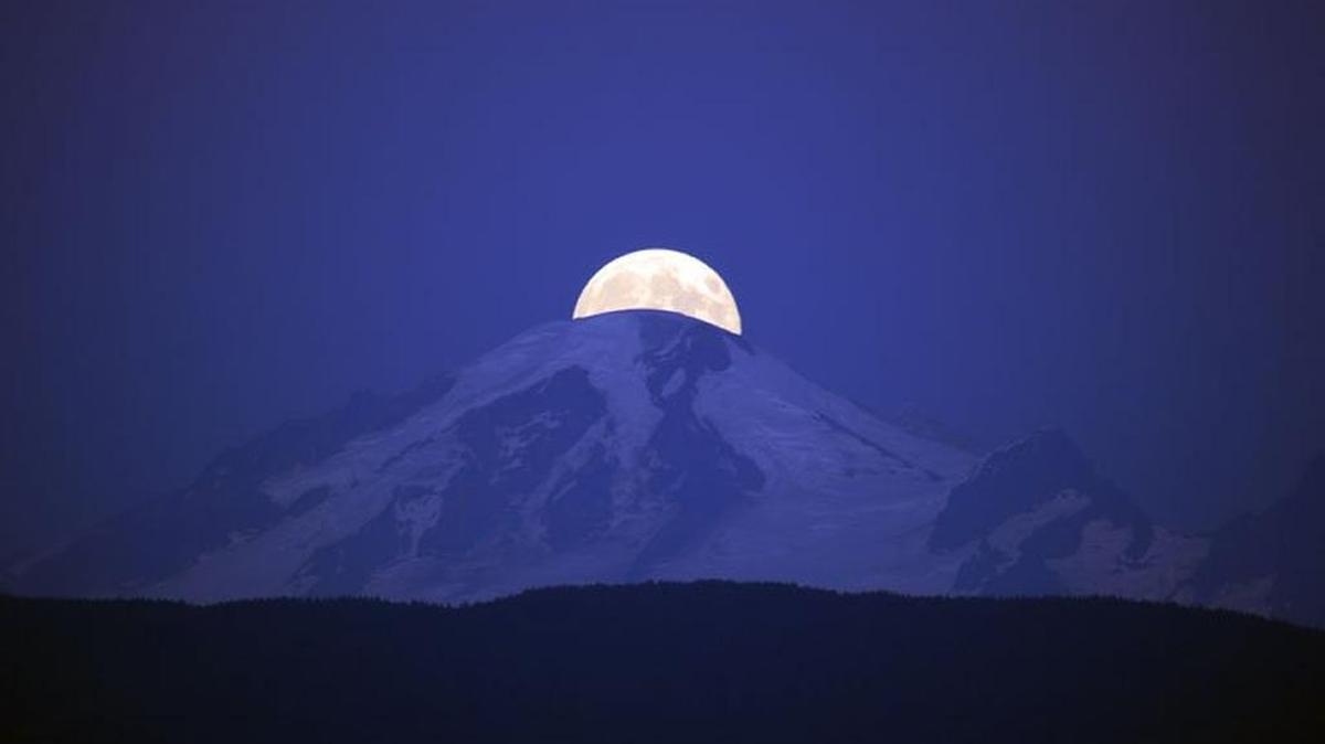 A supermoon rises behind Mount Baker in October, 2014.