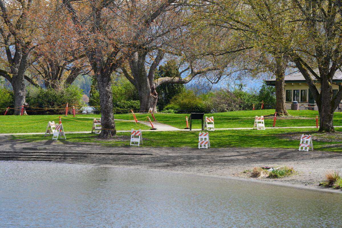 Closure signs and tape mark areas of Bloedel Donovan Park on Lake Whatcom on April 23, 2024, in Bellingham, Wash.