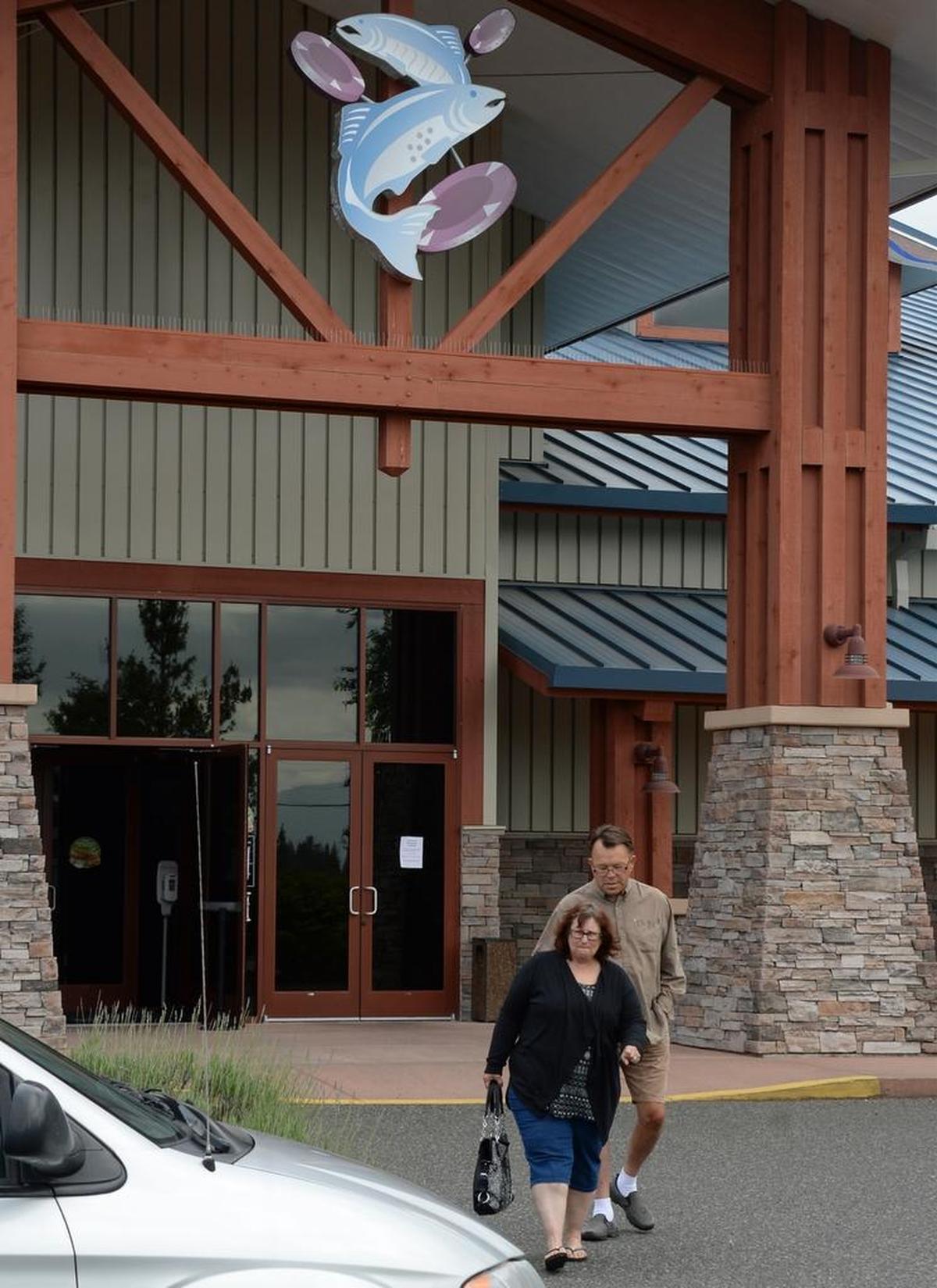 Judy and Glenn Carlson of Abbotsford, B.C., walk out of the closed Northwood Casino Wednesday morning, June 21, 2017, after cashing in their slot tickets. The casino was closed Friday night as ordered by The National Indian Gaming Commission.
