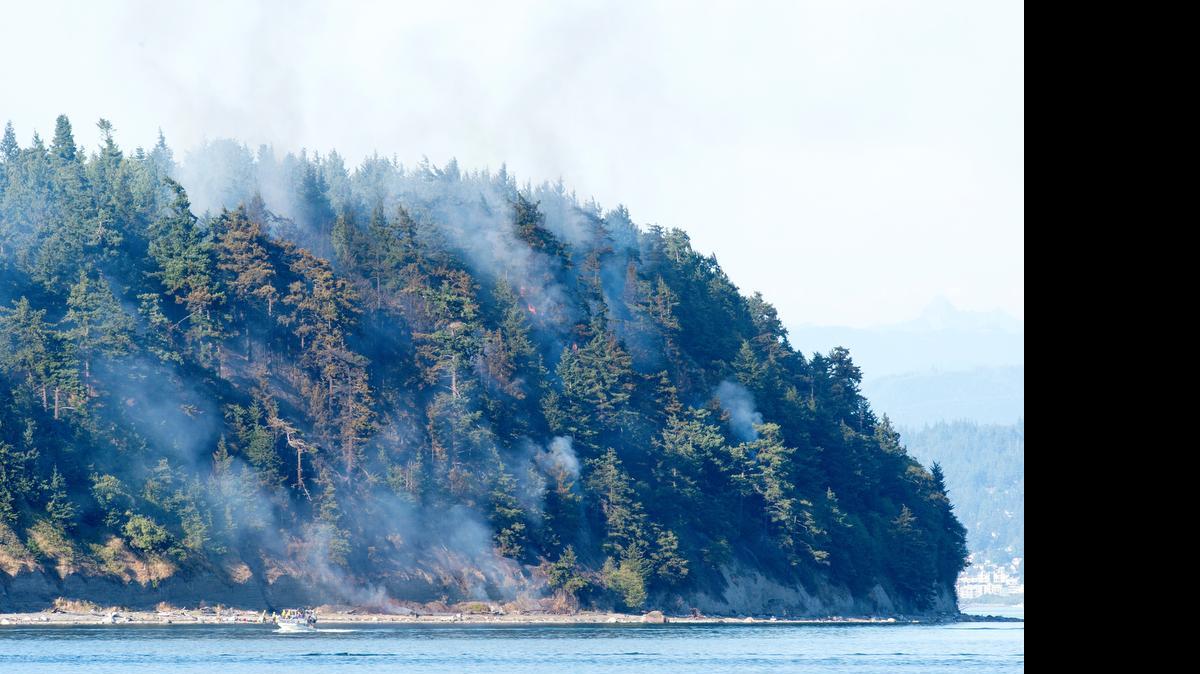 
A fire on Portage Island is pictured from Lummi Island on Saturday, July 4, near Bellingham, Washington.
