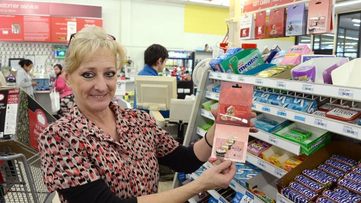 Assistant Manager Dawn Samora holds some Kmart gift cards at the Bellingham Kmart store, Tuesday, Dec. 27, 2016.