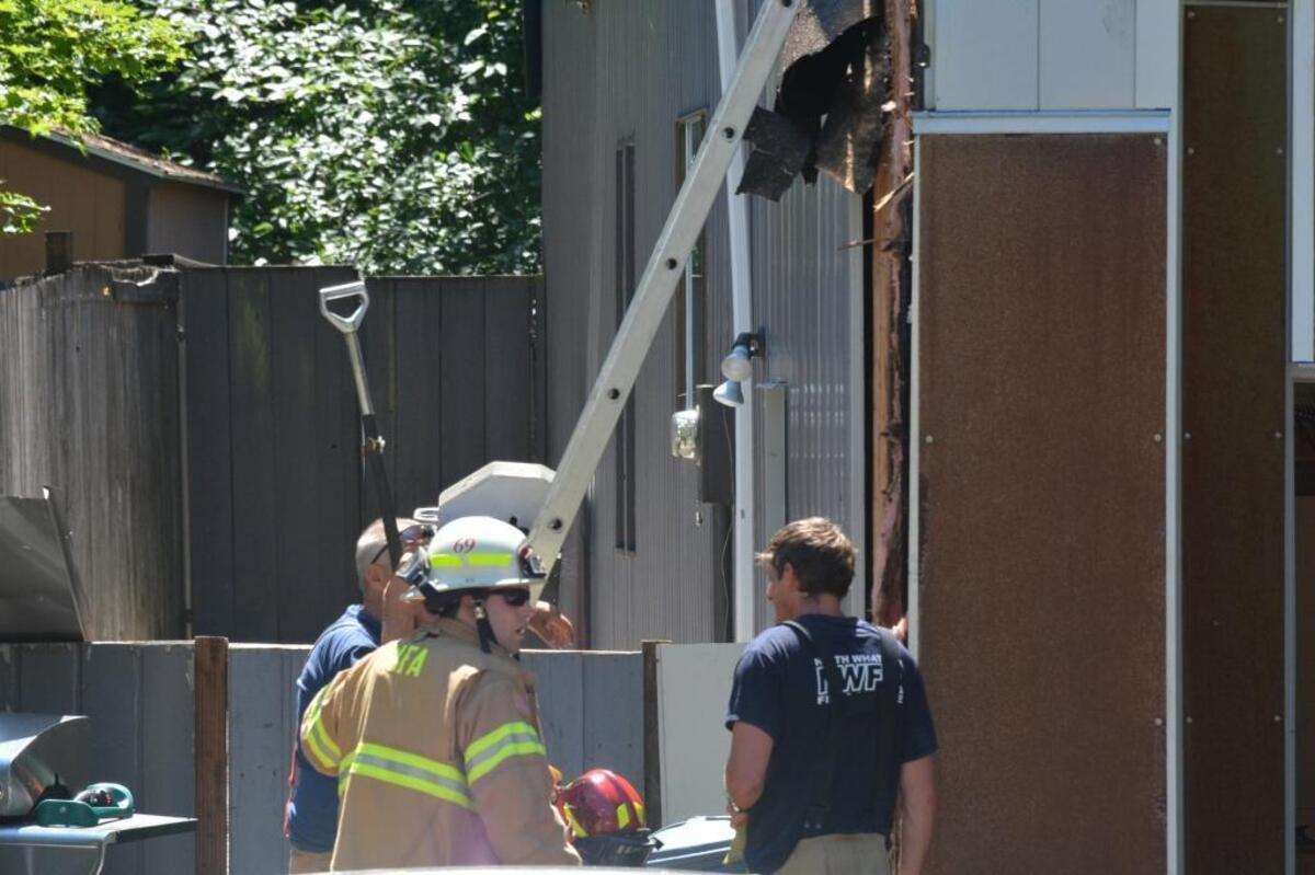 Firefighters examine the fire damage to a Tweed Twenty home on Sunday morning.