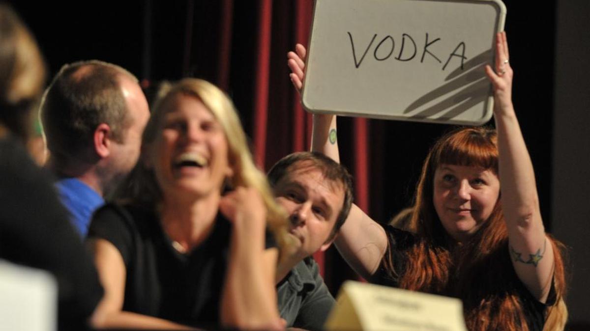 Cortney Moore holds up joking retort after failing to guess the right answer to a question during the Trivia Bee in 2012.