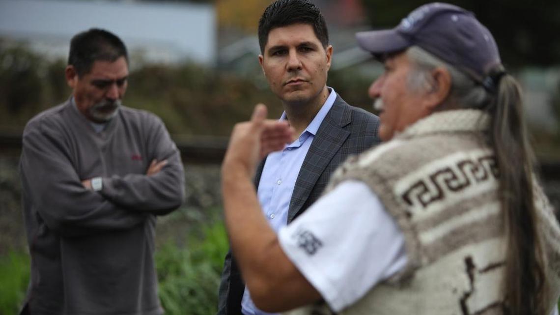 Native American lawyer Gabriel Galanda, center, listens to Nooksack members talk about disenrollment.