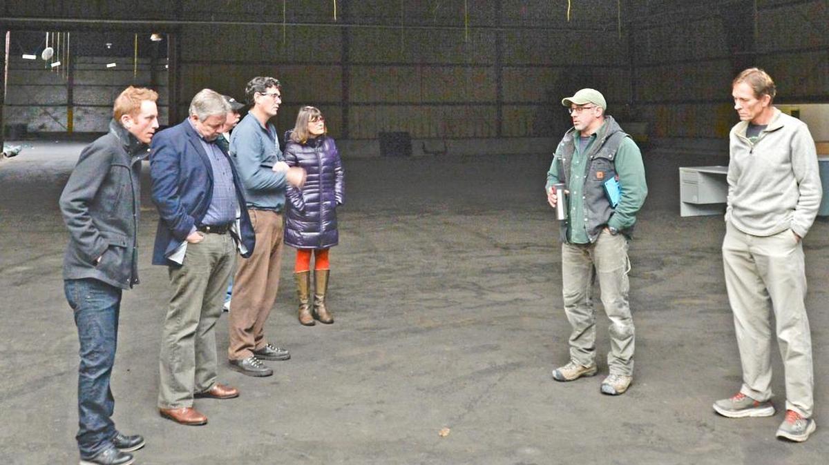 Port of Bellingham Commissioner Mike McAuley, center, leads a tour of the lignin building at the former Georgia-Pacific waterfront site in Bellingham, Tuesday Nov. 3, 2015. McAuley wants to convert the 50,000-square-foot building into an exposition center.