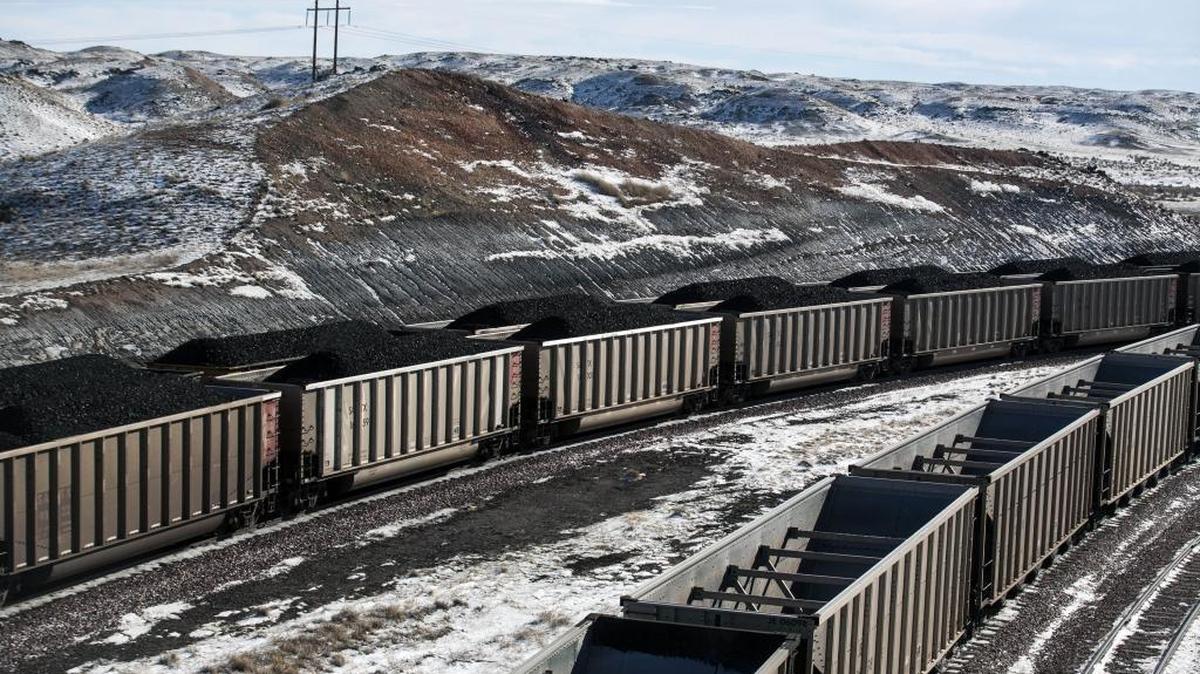 FILE - In this Jan. 9, 2014, file photo, rail cars are filled with coal and sprayed with a topper agent to suppress dust at Cloud Peak Energy’s Antelope Mine north of Douglas, Wyo.