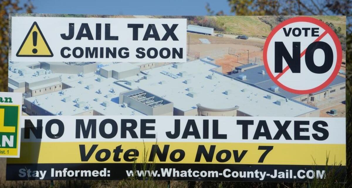 Sign overlooking Interstate 5 near Sunset Drive in Bellingham against building a new Whatcom County Jail.