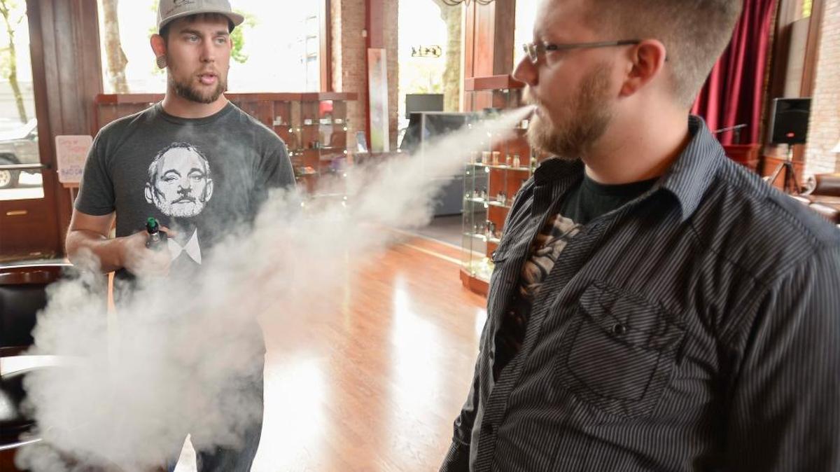 Customer Chris Lowe of Bellingham, left, talks to Master of Vapours owner Austin Masters at the downtown Bellingham electronic cigarette store Monday, May 16, 2016. Whatcom County is considering banning electronic cigarettes in bars and other public spaces.