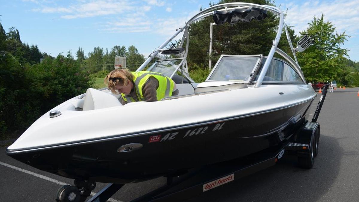 Alysia Herr, an aquatic invasive species inspector, checks out “Evil Kitty” on July 1, 2013, at the Bloedel Donovan Park entrance to Lake Whatcom. Despite the name, “Evil Kitty” wasn’t carrying anything harmful into the lake.