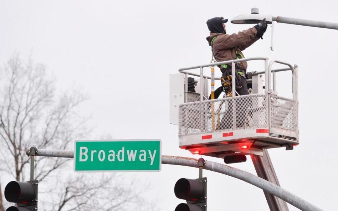 Floyd Elgin of Northwest Edison installs a new LED streetlight at the intersection of Broadway and Dupont streets in Bellingham on Dec. 21, 2015. Bellingham is changing out 3,600 streetlights from the current sodium lights to brighter, energy-saving LEDs.
