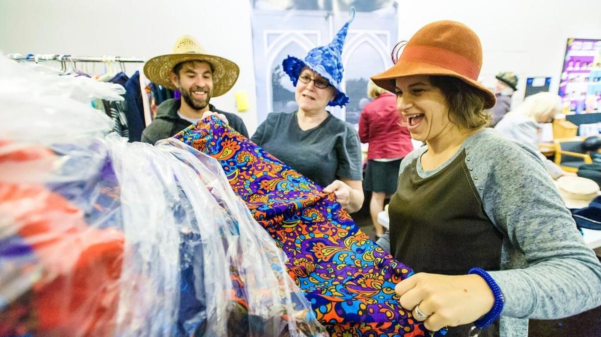 
Bellingham Theatre Guild costume chair Genny Cohn, center, shows Matt Friedlander, left, and his wife Meagan of Mount Vernon some of the costumes during BTG’s annual sale Saturday morning, Oct. 17, 2015, in Bellingham, Wash.
