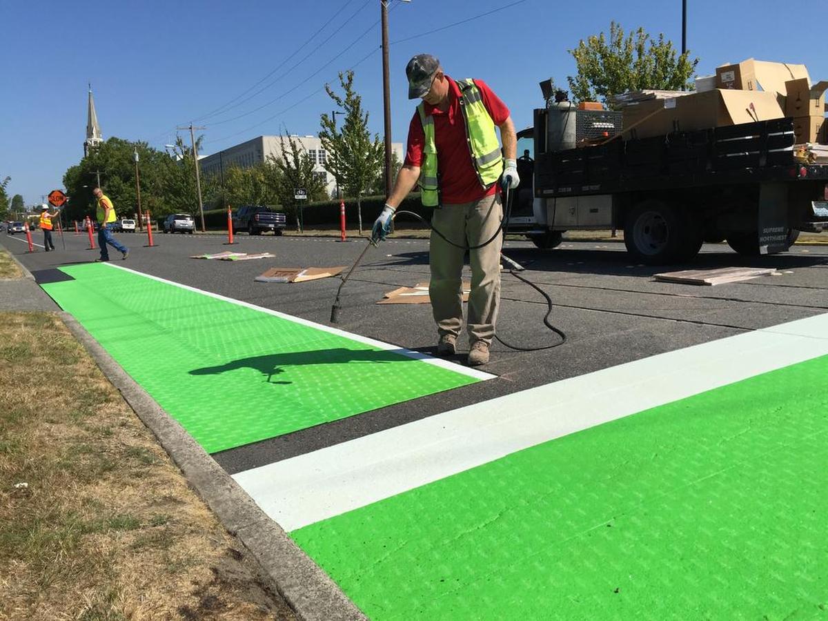 Green bike boxes allow cyclists to move closer to intersections in Bellingham.