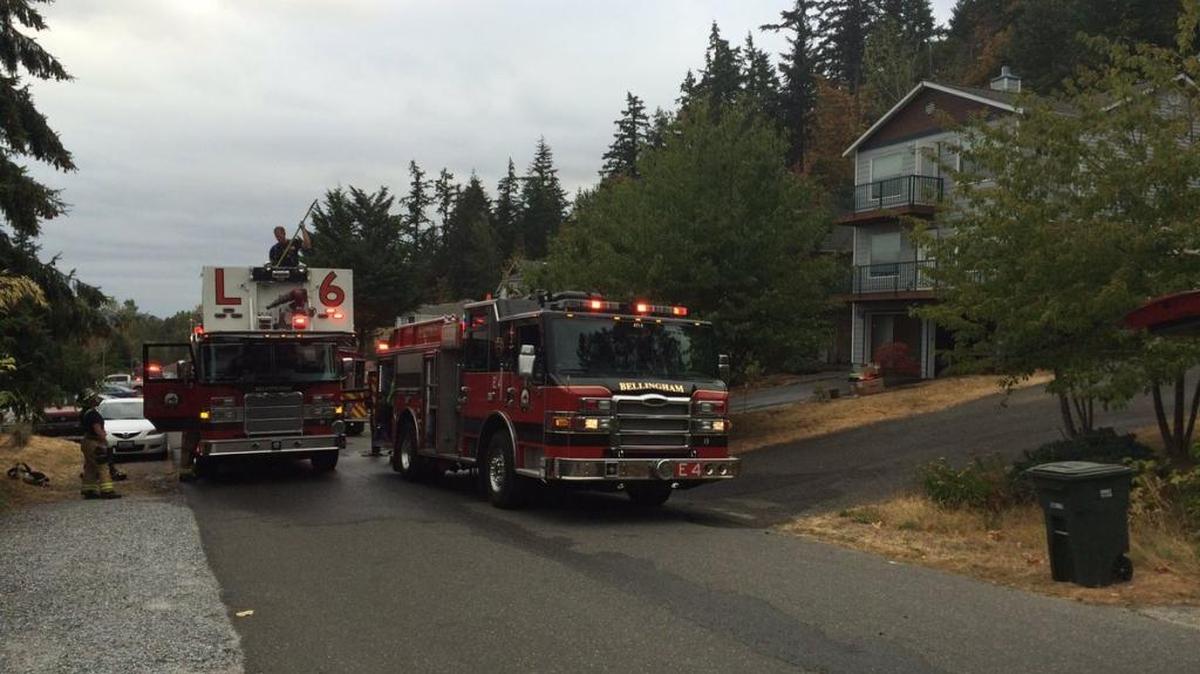 Ladder 6, left, and Engine 4 are parked outside the home at 133 44th St. on Sunday morning, Aug. 29.