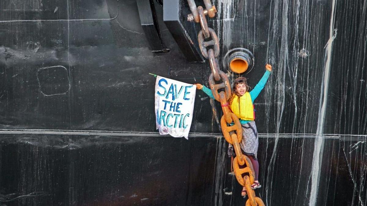 FILE - In this Friday, May 22, 2015 photo provided by Reese Semanko, Chiara D’Angelo hangs suspended in a climbing harness from the anchor chain of the Royal Dutch Shell support ship Arctic Challenger in the harbor at Bellingham, Wash. In her defense, D’Angelo argues that that her illegal action was necessary to avoid more serious harm; she faces a $20,000 fine.