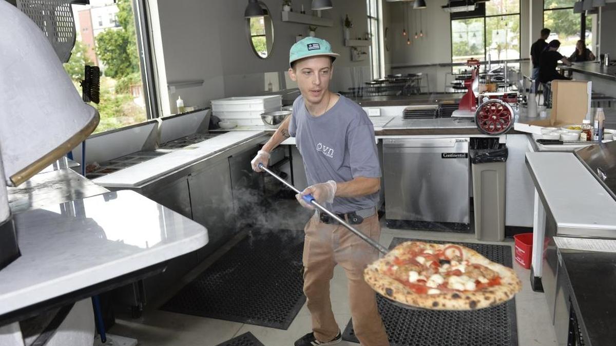 
Line cook Doug Jambor takes out a pizza at Ovn Wood Fire Pizza at 1148 10th St., near the South Bay Trail in Fairhaven. Ovn was one of 27 retail businesses that opened in Whatcom County between July and September.
