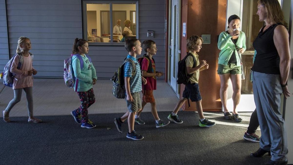 Students walk through the doors of Happy Valley Elementary on the first day of school in 2016. Bellingham students are the first in Whatcom County to go back to class, with schools back in session Aug. 23.