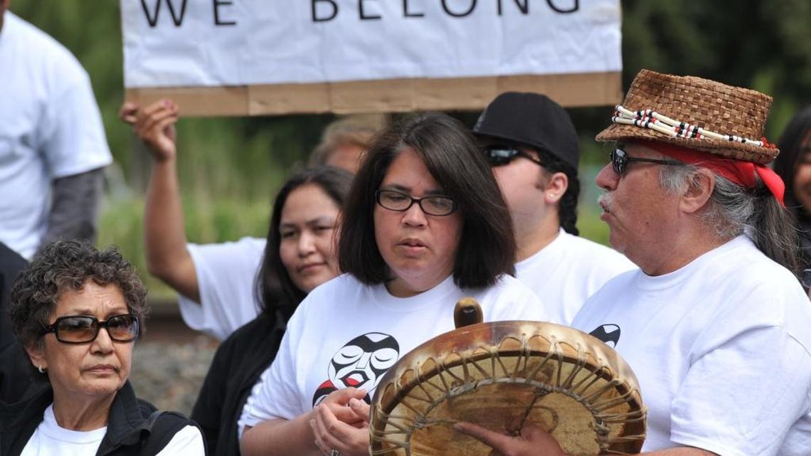 George Adams, right, sings with a crowd as they await a decision on whether the disenrollment process of 306 members of the Nooksack tribe would be allowed to proceed May 16, 2013, in front of the Nooksack Tribal Court in Deming.