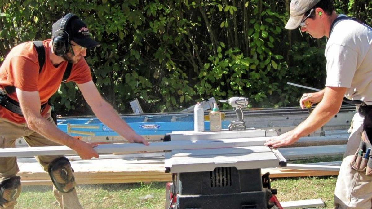 A-1 Builders employees Adam Yost and Chris Pasquini are busy at work on an exterior repair project in this undated photo. In July the company will become a worker-owned cooperative.