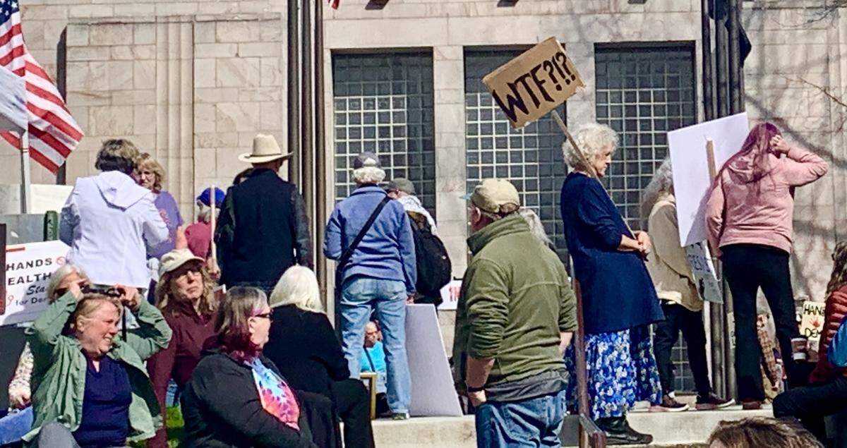 People gather near Bellingham City Hall on Saturday, April 5, 2025, prior to a Hands Off! protest.