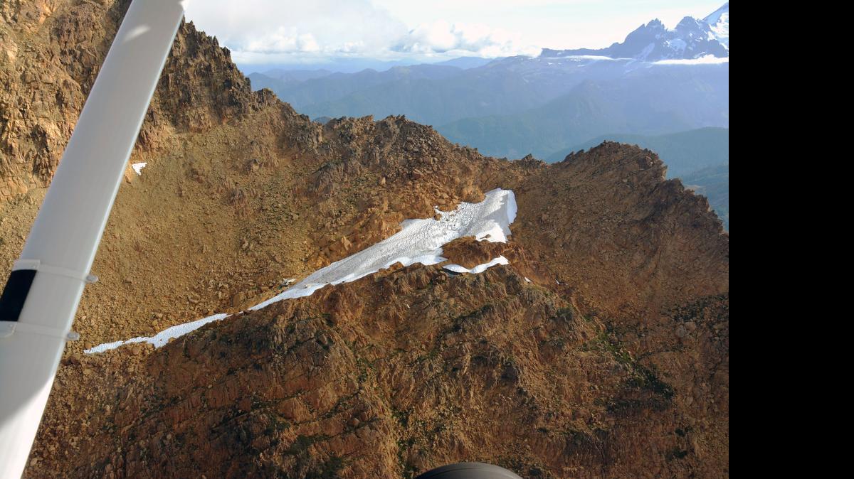 Washington State Department of Transportation provided this photo showing wreckage, just above the snowfield at center, believed to be of a Minnesota plane found in the Twin Sisters mountains east of Acme on Wednesday morning, July 15. Search crews will need to reach the site to make an official confirmation.
