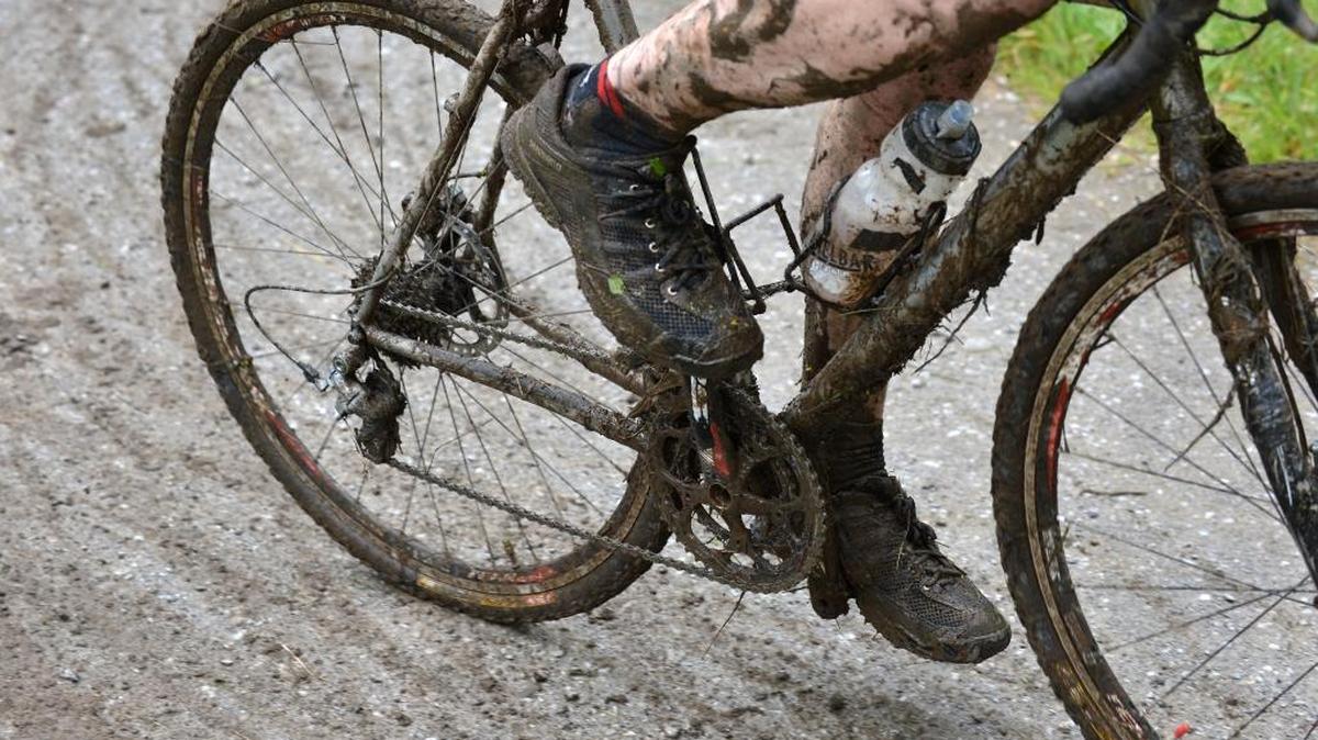 Mud sticks to a mountain bike rider and bike after riding through the trails during the cyclocross leg of the 2013 Ski to Sea race on May 26, 2013. A cyclist practicing this year’s course went through restricted airport property, prompting a reminder from race officials to stay out of that area.