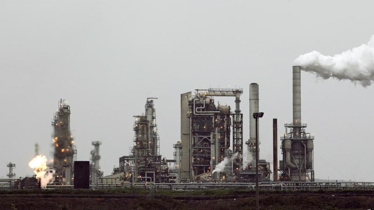 FILE - This April 2, 2010 file photo shows a Tesoro Corp. refinery, including a gas flare flame that is part of normal plant operations, in Anacortes, Wash.