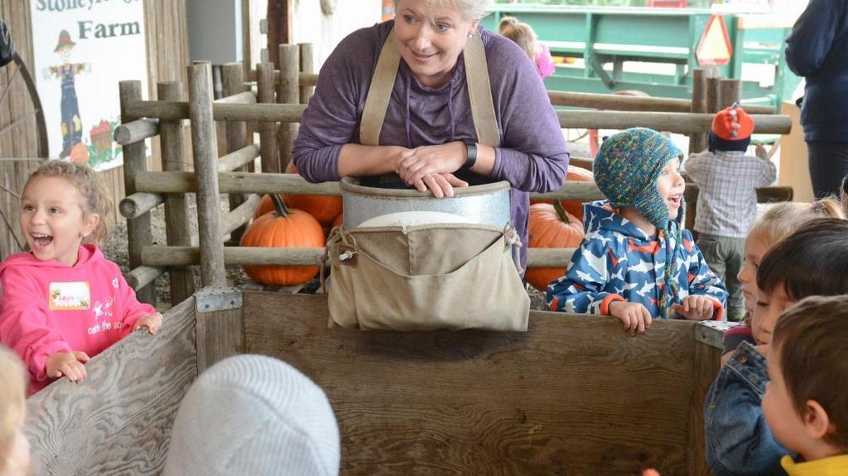 
Stoney Ridge Farm co-owner Debi Gavette shows a group of school kids how apples are harvested during the farm’s final annual fall festival in Everson on Thursday, Oct. 8, 2015. The farm is open Thursdays through Saturdays through Halloween for u-pick pumpkins and apples, hayrides and farm tours. The farm still will be open in winter for Christmas trees.
