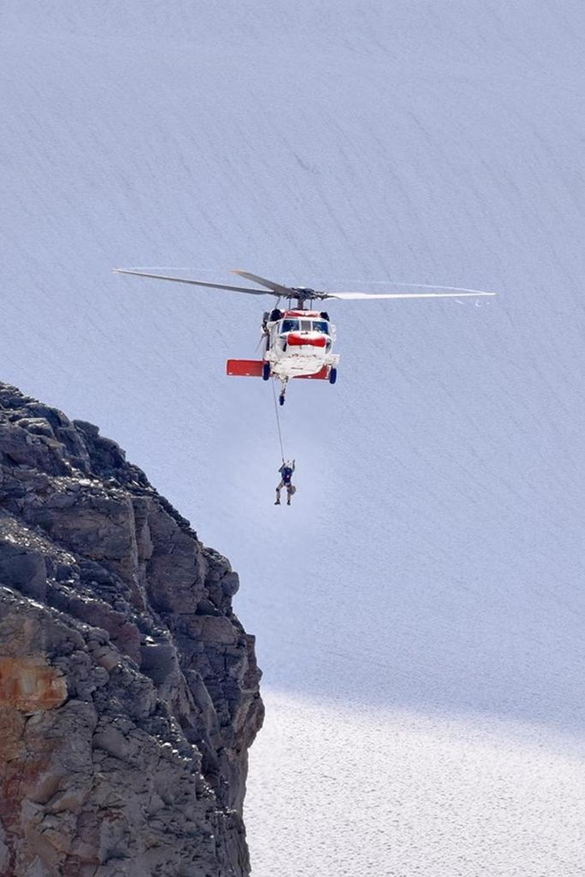 Navy search and rescue team members from Whidbey Island Naval Air Station rescue an injured climber from the slopes of Mount Baker on Saturday, Aug. 19.