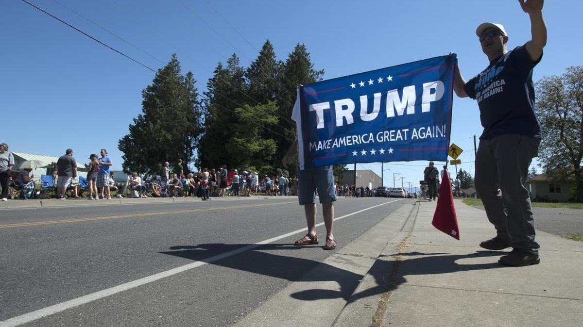 Donald Trump supporters hold a banner and wave at passing cars before Trump’s rally at the Northwest Washington Fairgrounds on May 7 in Lynden. Ballots for Washington state’s presidential primary are due May 24, but all of Trump’s opponents have already dropped out and Democrats don’t use the primary results to award delegates.