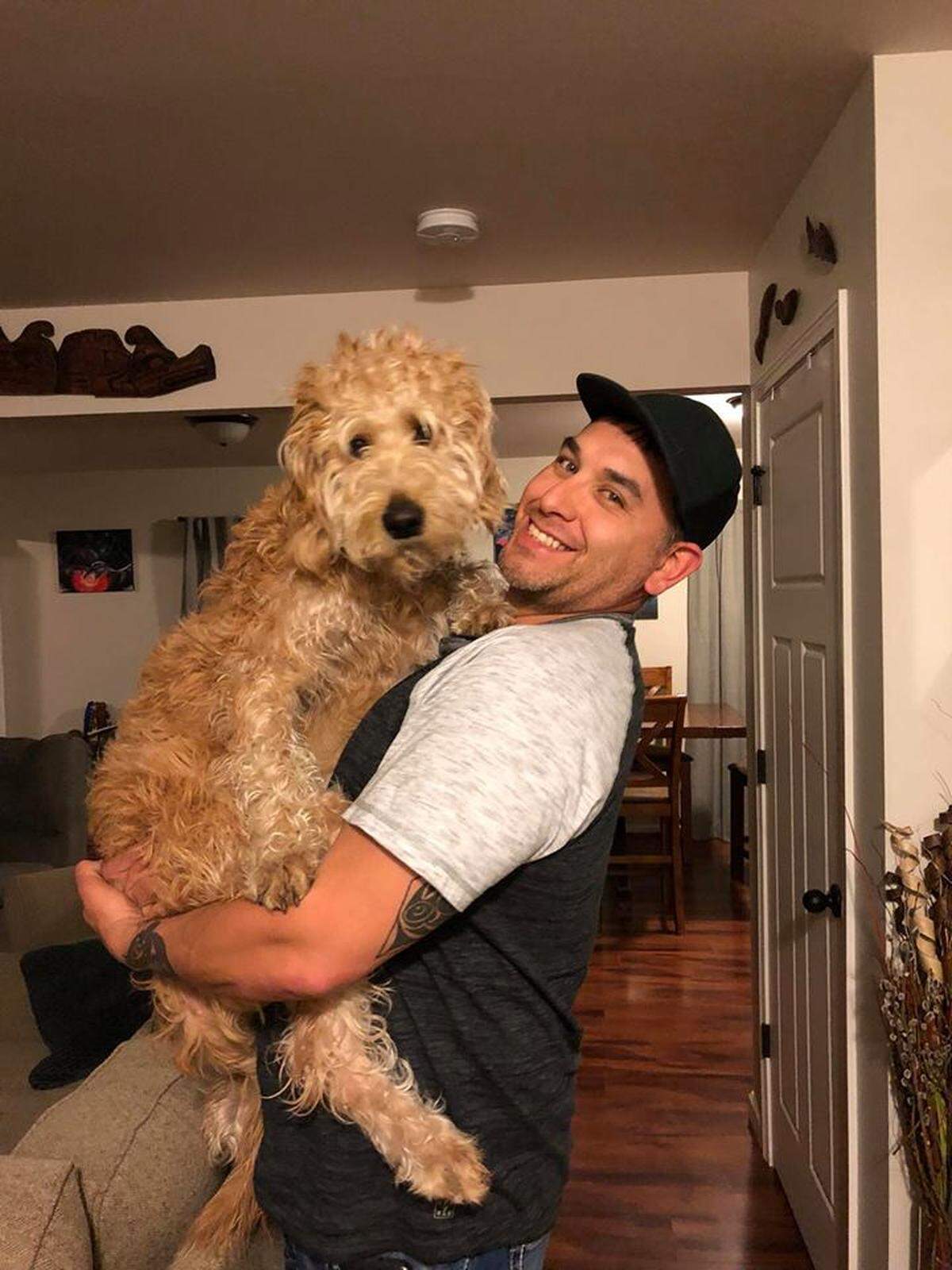Joseph Johnson with Jax. Johnson’s labradoodle allegedly was shot by a neighbor Saturday morning, Sept. 1, near Bellingham.