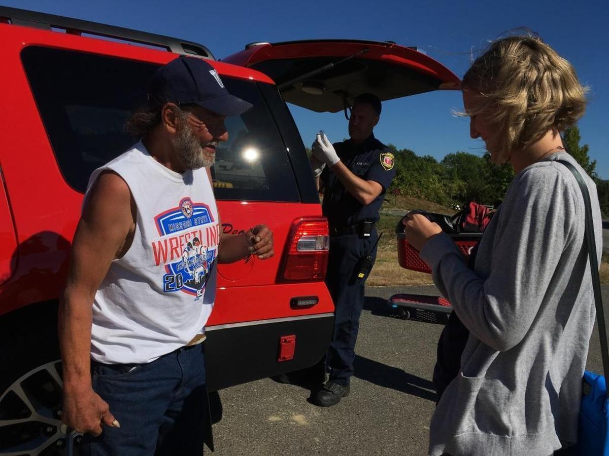 Carlos Abitia, left, chats with Andrea Day, right, during a recent call to evaluate his needs and deliver a monthly injection that is designed to control alcohol addiction. Bellingham Fire Capt. Jeff Brubaker prepares the medication in the background.