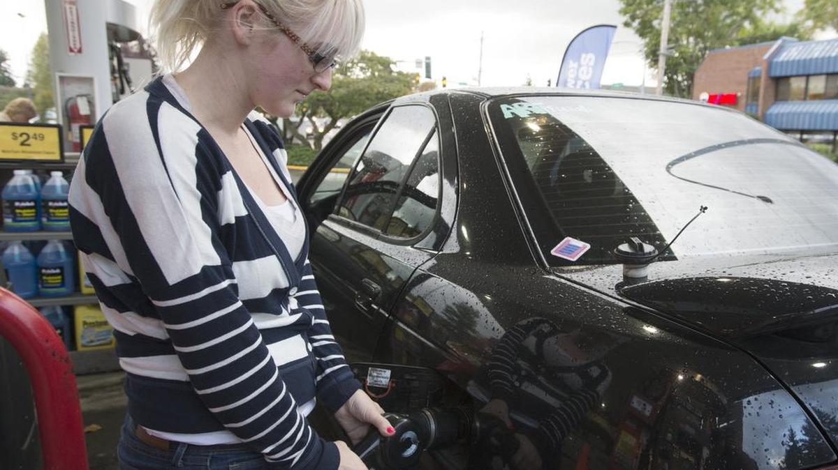 
Kelly Torvik of Bellingham fills the gas tank of her car Oct. 20, 2014 at the Lakeway Fred Meyer.
